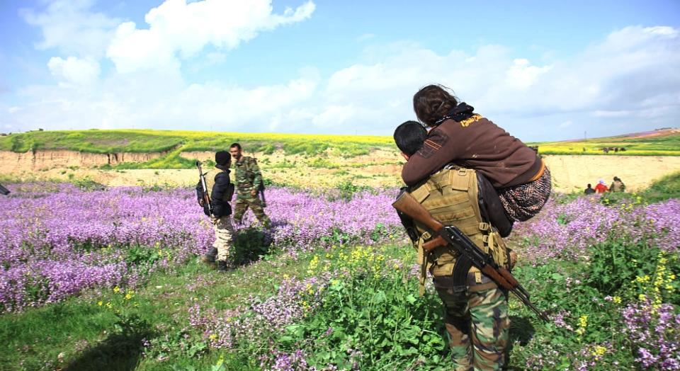 She is carried across the frontline by a soldier.