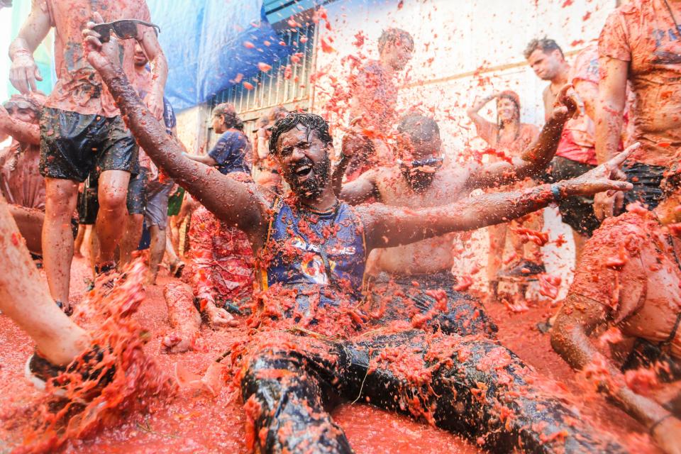 Participants throw tomatoes at each other during the annual "Tomatina" tomato fight fiesta Aug. 31, 2022.