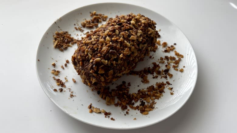 chocolate cheese fudge coated with walnuts on plate