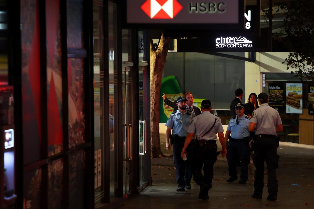 Australian police and shopping center staff are seen outside Westfield Bondi Junction on April 13, 2024, in Australia.