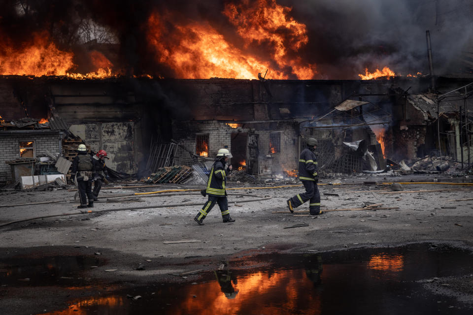 Firefighters work to extinguish a fire at a warehouse after it was hit by Russian shelling, March 28, in Kharkiv, Ukraine