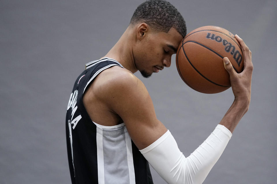 San Antonio Spurs center Victor Wembanyama, the NBA's first round draft pick, poses for photos during an NBA basketball media day in San Antonio, Monday, Oct. 2, 2023. (AP Photo/Eric Gay)