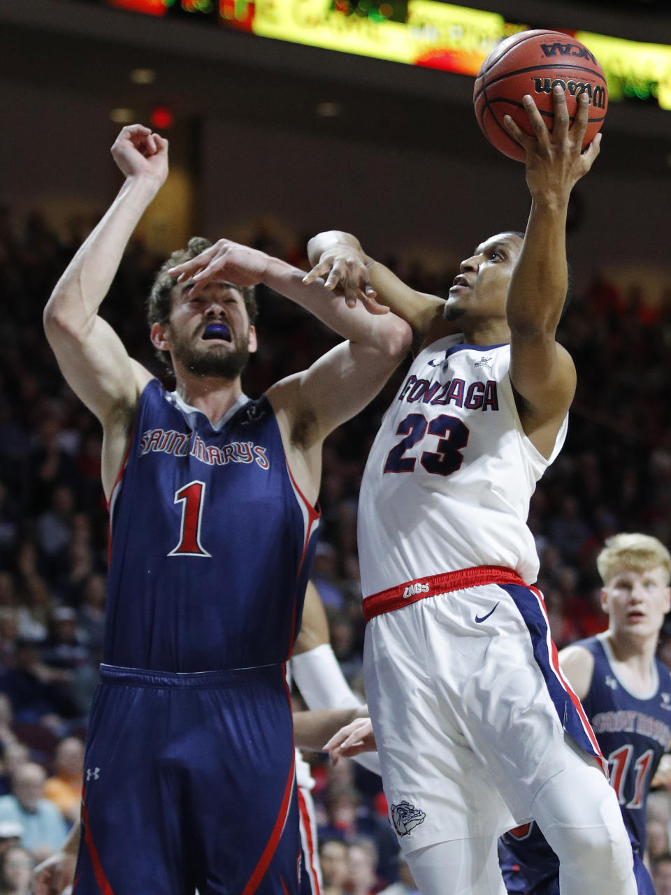 Gonzaga's Zach Norvell Jr. (23) shoots around St. Mary's Jordan Hunter during the first half of an NCAA college basketball game for the West Coast Conference men's tournament title, Tuesday, March 12, 2019, in Las Vegas. (AP Photo/John Locher)