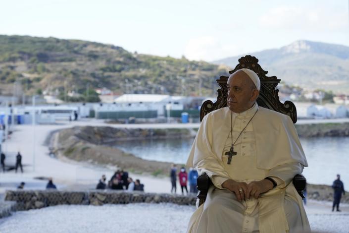 Pope Francis attends a ceremony at the Karatepe refugee camp, on the northeastern Aegean island of Lesbos, Greece, Sunday, Dec. 5, 2021. Pope Francis is returning to Lesbos, the Greek island that was at the heart of a massive wave of migration into Europe. (AP Photo/Alessandra Tarantino)