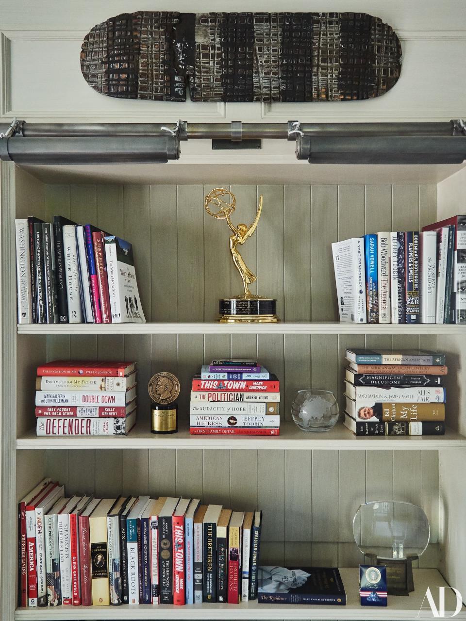 Library shelves hold Rhimes's 2016 Emmy, 2013 Peabody, and the Television Academy's 24th Hall of Fame award.