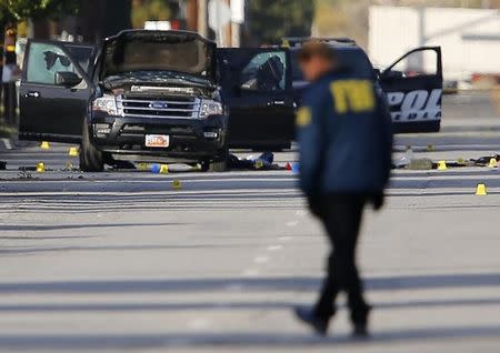 FBI and police continue their investigation around the area of the SUV vehicle where two suspects were shot by police following a mass shooting in San Bernardino, California December 3, 2015. REUTERS/Mike Blake