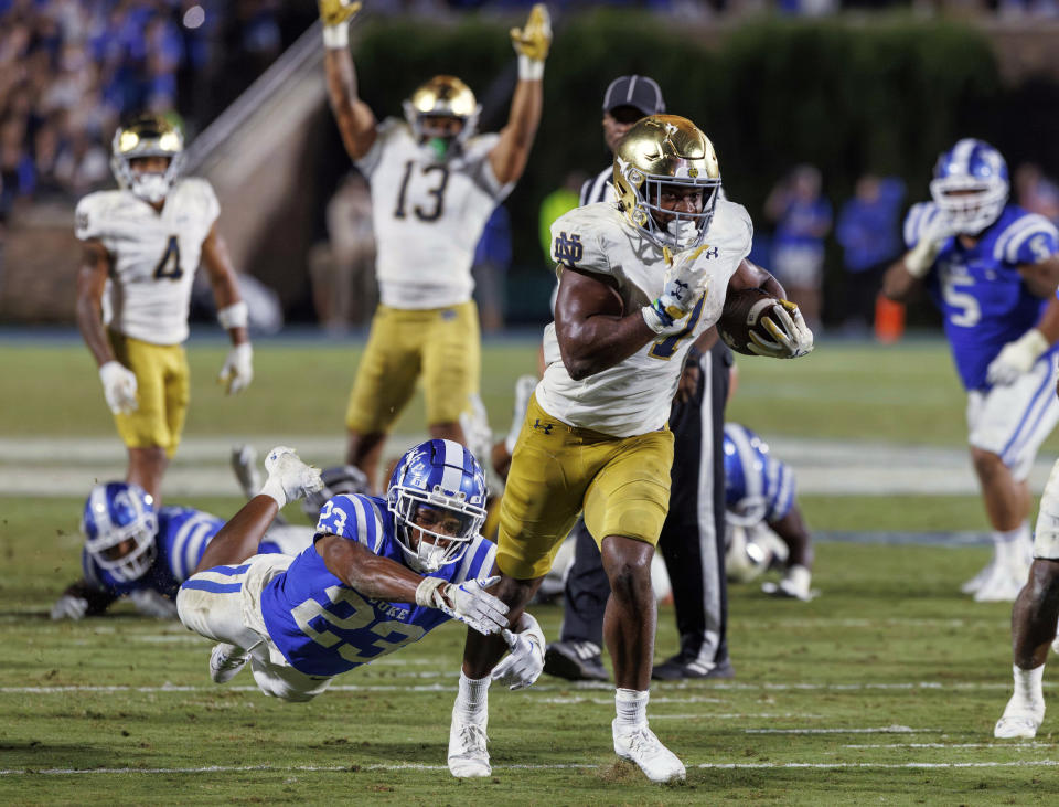 Notre Dame's Audric Estimé (7) carries the ball past Duke's Terry Moore (23) for the go-ahead and eventual game-winning touchdown in Durham, N.C., Saturday, Sept. 30, 2023. (AP Photo/Ben McKeown)