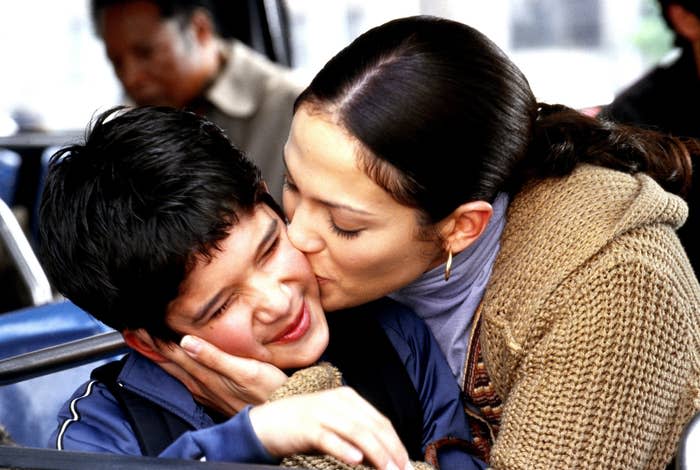 Jennifer Lopez giving him a kiss on the cheek