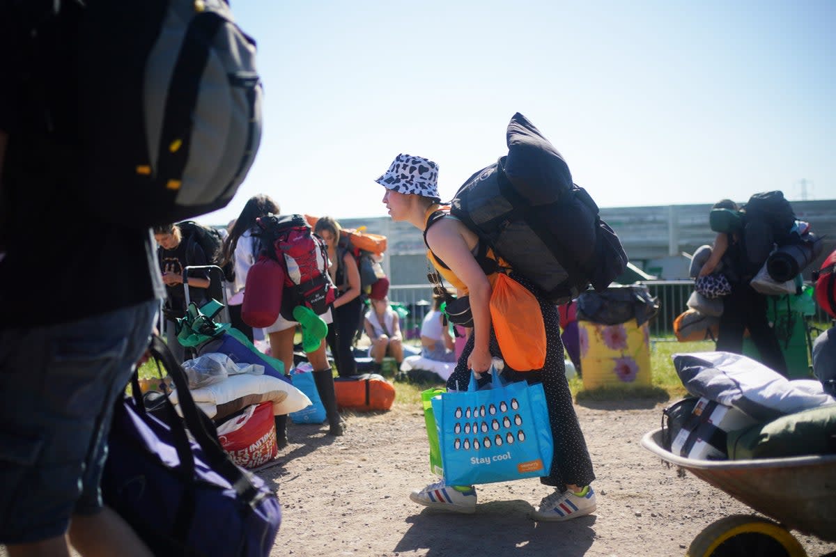 People arrive on the first day of the Glastonbury Festival at Worthy Farm in Somerset (Yui Mok/PA) (PA Wire)