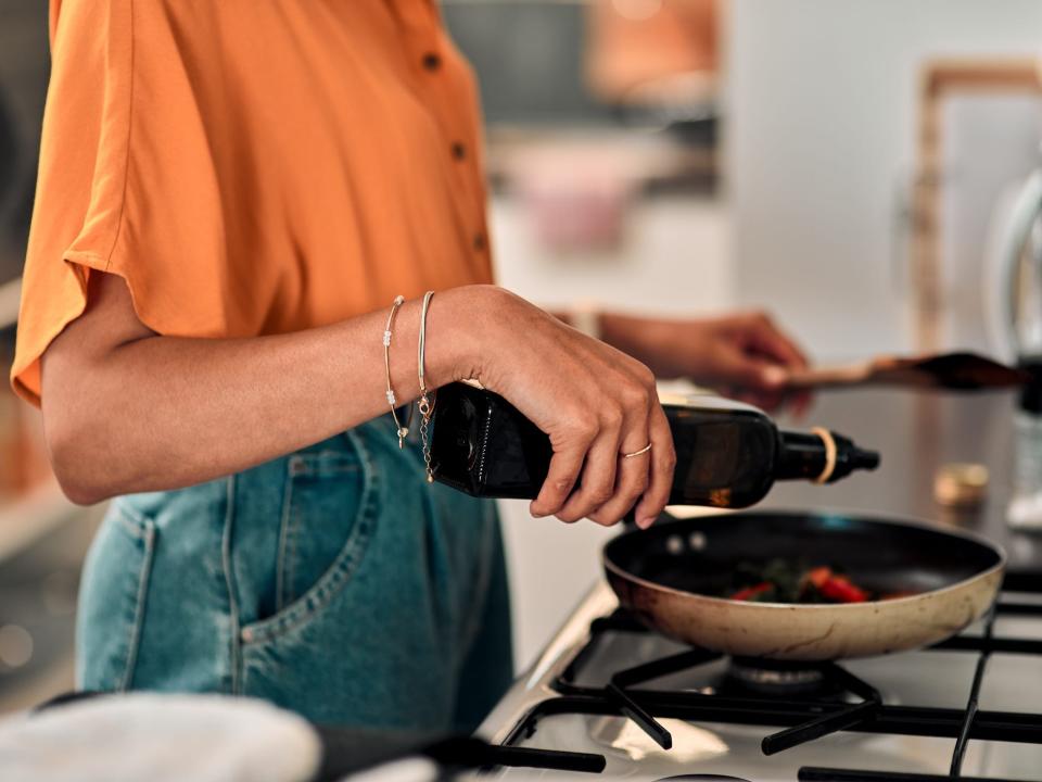 A woman cooking on the stove.