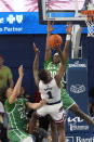 Florida Atlantic guard Johnell Davis (1) goes up for a shot against North Texas guard CJ Noland (22) and guard John Buggs III (00) during the second half of an NCAA college basketball game, Sunday, Jan. 28, 2024, in Boca Raton, Fla. (AP Photo/Wilfredo Lee)