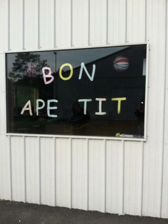 The image shows a window with the phrase "BON APE TIT" spelled out in colored letters, with "BON" and "TIT" separated, creating humorous spacing