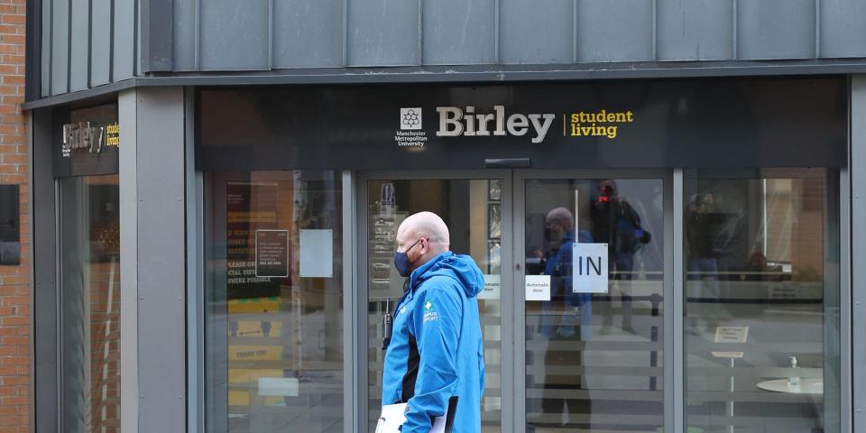 A man wearing a facemask at Manchester Metropolitan University's Birley campus where hundreds of students have been told to self-isolate after 127 of them tested positive for coronavirus. (Photo by Peter Byrne/PA Images via Getty Images)