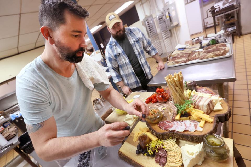 Paradox Charcuterie's Chef Jimmy Gentry and Charcutier Mitchell Marable prepare a board featuring house made jams, pickles, duck prosciutto and pate noisette, amongst a full spread created and cured at their shop on Thursday, January 13, 2022.