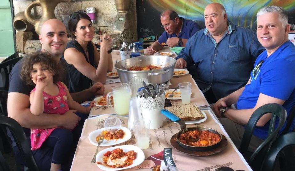 Shai Fargian, his family and Frank Scibelli eat with chef Bino Gabso at Dr. Shakshuka restaurant in Tel Aviv, Israel.