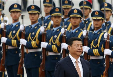 Chinese President Xi Jinping inspects an honour guard at a welcoming ceremony for Venezuelan President Nicolas Maduro outside the Great Hall of the People in Beijing in this September 22, 2013 file photo. REUTERS/Kim Kyung-Hoon/Files