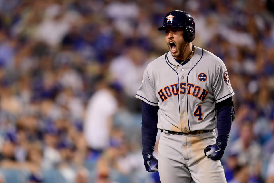 <p>George Springer #4 of the Houston Astros celebrates after hitting a two-run home run during the eleventh inning against the Los Angeles Dodgers in game two of the 2017 World Series at Dodger Stadium on October 25, 2017 in Los Angeles, California. (Photo by Harry How/Getty Images) </p>