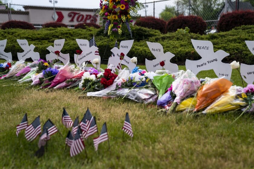 BUFFALO, NY - MAY 20: Flowers placed at a memorial are seen at the Tops Friendly Market at Jefferson Avenue and Riley Street on Friday, May 20, 2022 in Buffalo, NY. The fatal shooting of 10 people at the Tops supermarket in a historically Black neighborhood of Buffalo by a young white gunman is being investigated as a hate crime and an act of "racially motivated violent extremism," according to federal officials. (Kent Nishimura / Los Angeles Times)