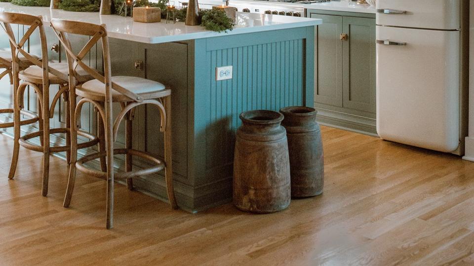 green kitchen filled with greenery and garland