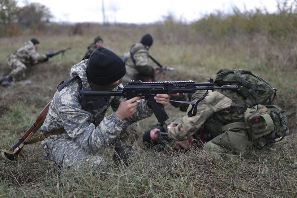 FILE - Recruits hold their weapons during a military training at a firing range in the Krasnodar region in southern Russia, Oct. 21, 2022. Since Russian President Vladimir Putin announced his mobilization on Sept. 21 for the war in Ukraine, independent media, human rights activists and draftees themselves have painted a bleak picture of a haphazard, chaotic and ethnically biased effort to round up as many men as possible and push them quickly to the front, regardless of skill or training. (AP Photo/File)