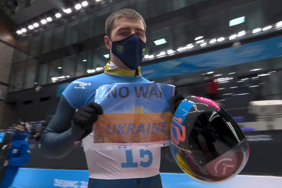 Vladyslav Heraskevych, of Ukraine, holds a sign that reads ‘No War in Ukraine' after finishing a run at the men’s skeleton competition (AP)