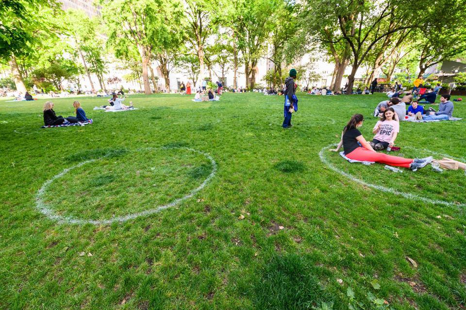 People practice social distancing in white circles in Madison Square Park during the coronavirus pandemic on May 24, 2020, in New York City.