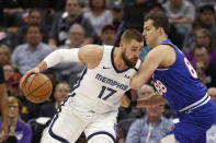 Memphis Grizzlies center Jonas Valanciunas, left, drives against Sacramento Kings forward Nemanja Bjelica during the first quarter of an NBA basketball game in Sacramento, Calif., Thursday, Feb. 20, 2020. (AP Photo/Rich Pedroncelli)