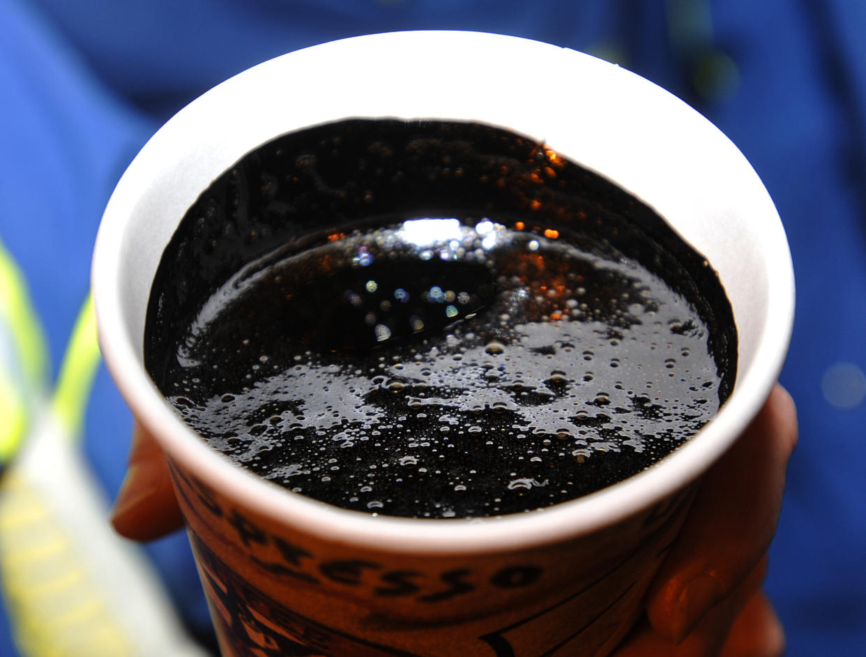 A cup of heavy oil produced at the Statoil oil sands operation near Conklin, Alberta, November 3, 2011. Statoil plans an expansion of their oil sands operation that will let them produce 60,000 barrels of oil per day by 2016. REUTERS/Todd Korol (CANADA - Tags: BUSINESS ENERGY)