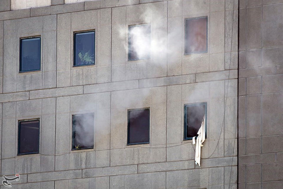 <p>Smoke is seen during an attack on the Iranian parliament in central Tehran, Iran, June 7, 2017. (Photo: Tasnim News Agency/Handout via Reuters) </p>