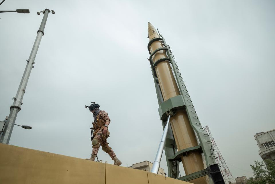 An Islamic Revolutionary Guard Corps (IRGC) military personnel walks next to an Iranian Emad Surface-to-Surface missile in downtown Tehran during a rally commemorating the International Quds Day, also known as the Jerusalem day, on April 29, 2022.