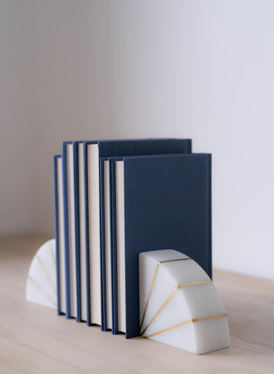 The debut collection includes a set of stone marble bookends with gold detail, priced at $58.