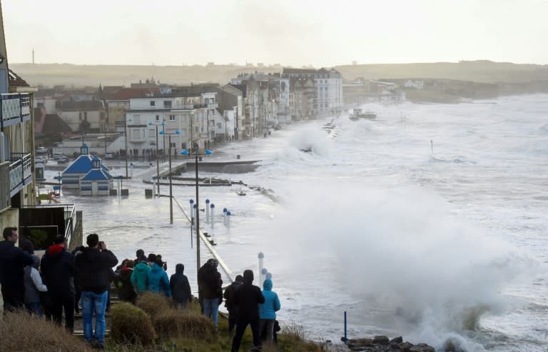 A crowd watched as massive waves flooded the seafront of Wimereux, northern France, on Wednesday