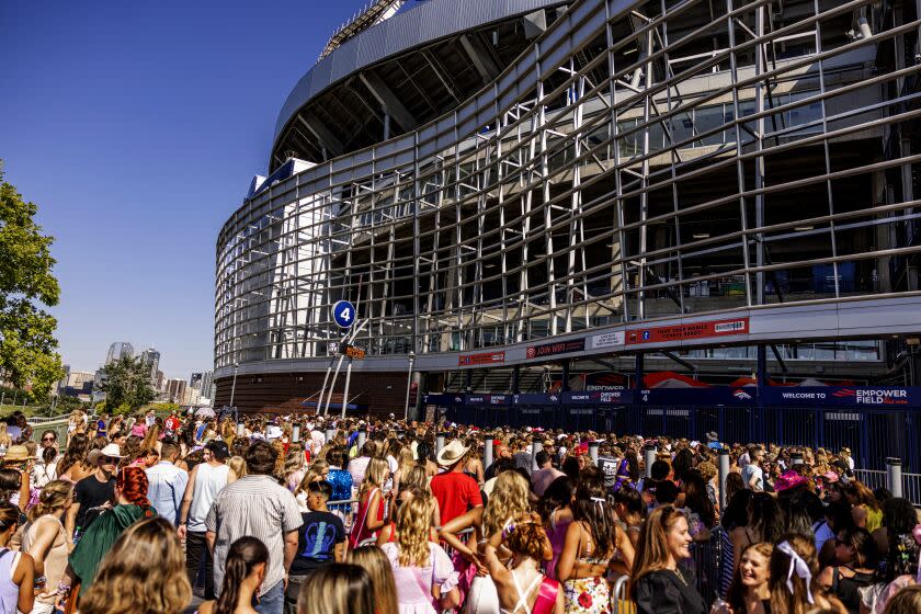 Fans wait to enter the stadium before Taylor Swift performs in Denver, Colo., on Friday, July 14, 2023.