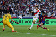 Barcelona's Pedri, right, scores his side's 3rd goal during a Spanish La Liga soccer match between Barcelona and Rayo Vallecano at the Olimpic Lluis Companys stadium in Barcelona, Spain, Sunday, May 19, 2024. (AP Photo/Joan Monfort)