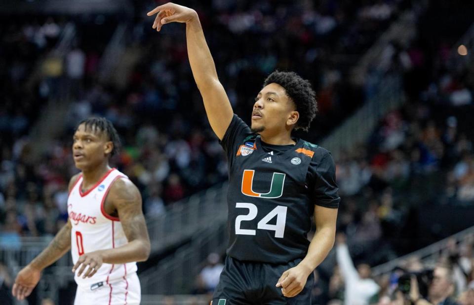 Miami guard Nijel Pack (24) launches a three-point shot against Houston during a Sweet 16 college basketball game in the Midwest Regional of the NCAA Tournament Friday, March 24, 2023, in Kansas City.