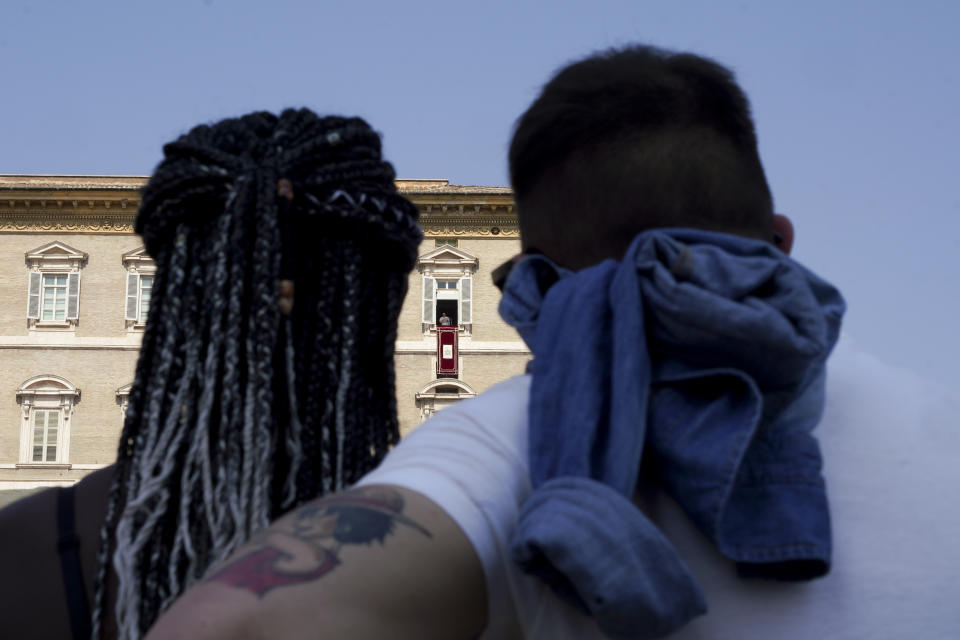 Faithful listen to Pope Francis delivering the Angelus noon prayer from the window of his studio overlooking St. Peter's Square, at the Vatican, Sunday, Sept. 13, 2020. (AP Photo/Andrew Medichini)