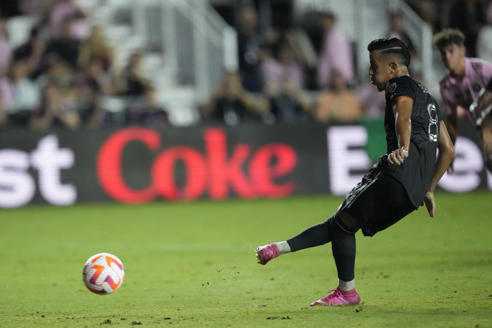 Houston Dynamo midfielder Amine Bassi (8) scores on a penalty in the first half of the U.S. Open Cup final soccer match against Inter Miami, Wednesday, Sept. 27, 2023, in Fort Lauderdale, Fla. (AP Photo/Rebecca Blackwell)