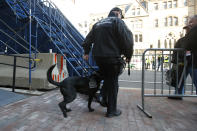 A Boston police officer and security dog pass by the photo bridge at the finish line for the 118th Boston Marathon Monday, April 21, 2014 in Boston. (AP Photo/Elise Amendola)