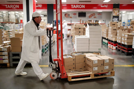 A man pushes a trolley in the poultry pavilion in the Rungis International wholesale food market as buyers prepare for the Christmas holiday season in Rungis, south of Paris, France, December 6, 2017. Picture taken December 6, 2017. REUTERS/Benoit Tessier