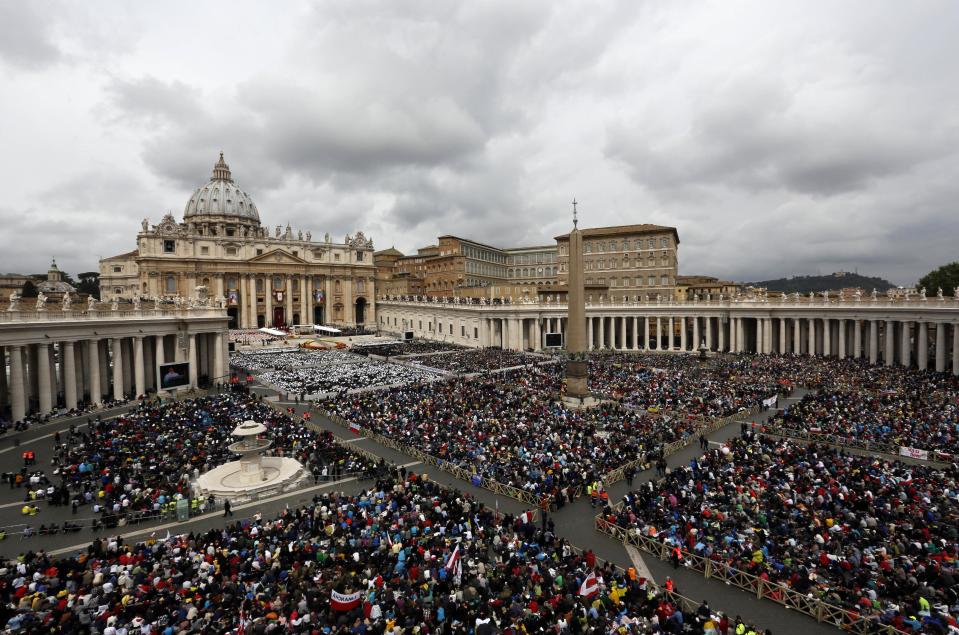 Faithful gather in St. Peter's Square at the Vatican, Sunday, April 27, 2014. Pope Francis has declared his two predecessors John XXIII and John Paul II saints in an unprecedented canonization ceremony made even more historic by the presence of retired Pope Benedict XVI.(AP Photo/Alessandra Tarantino)