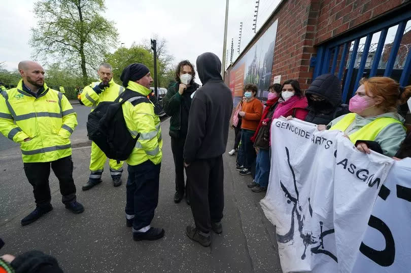 Some workers negotiate entry as protesters form a blockade outside weapons manufacturer BAE Systems in Glasgow