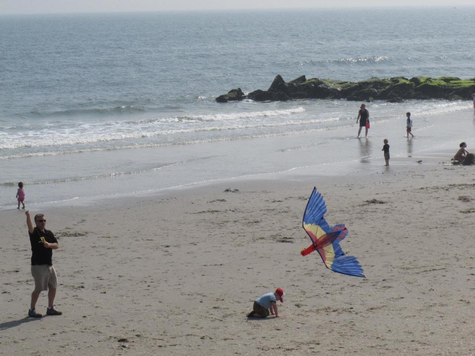 In this March 23, 2012, photo, Ron Gilleo, left, flies a kite on an Ocean City, N.J. beach. Voters in New Jersey's Ocean City will decide an issue that has roiled this seaside community for decades: whether to allow restaurant patrons to bring their own beer or wine to enjoy with meals. (AP Photo/Wayne Parry)