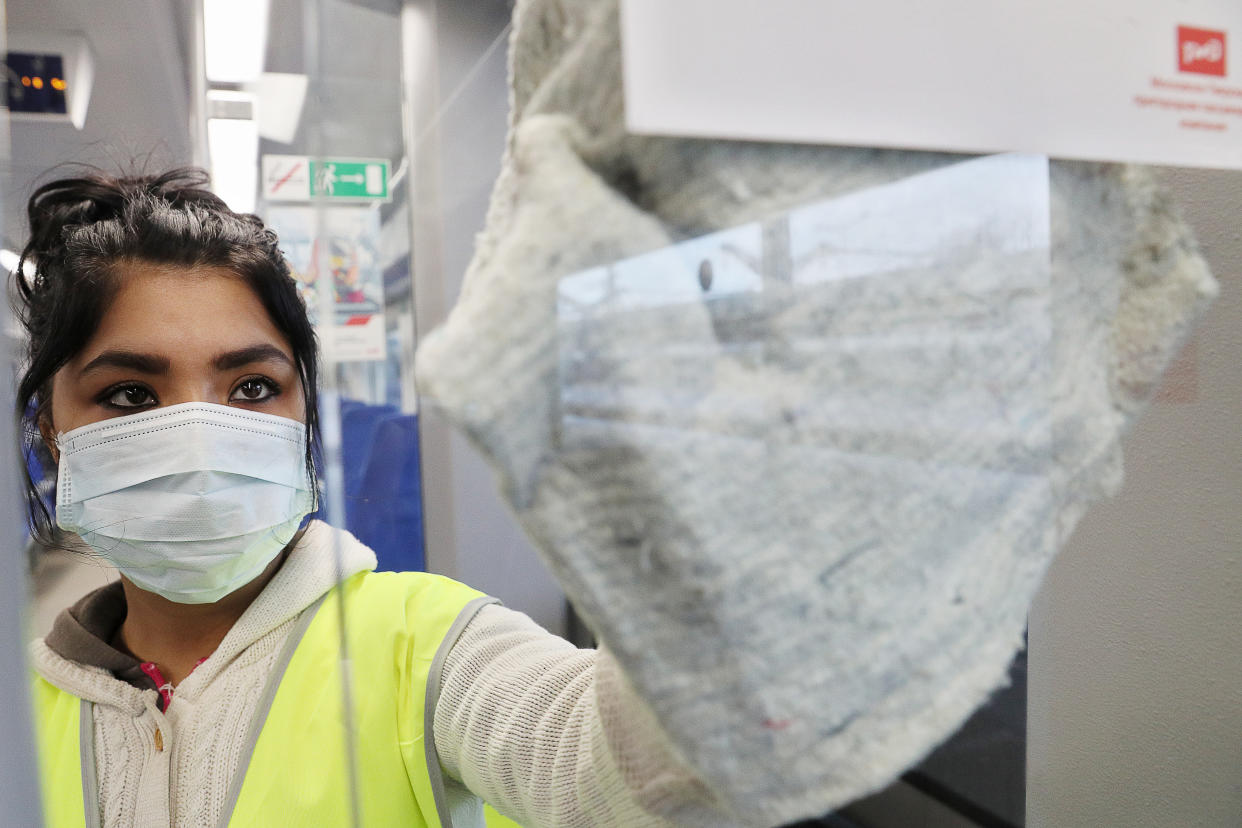 MOSCOW, RUSSIA - MARCH 20, 2020: A cleaner in a face mask cleans and disinfects a suburban commuter train at Leningradsky Railway Station during the pandemic of the novel coronavirus (COVID-19). As of 20 March 2020, Russia has confirmed more than 200 cases of the novel coronavirus, with more than 100 confirmed cases in Moscow. Alexander Shcherbak/TASS (Photo by Alexander Shcherbak\TASS via Getty Images)