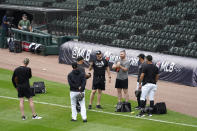 Chicago White Sox pitching coach Ethan Katz, center, talks with his players after Game 4 of an ALDS baseball game was postponed due to a forecast of inclement weather Monday, Oct. 11, 2021, in Chicago. The makeup game is scheduled for Tuesday afternoon at Guaranteed Rate Field. (AP Photo/Charles Rex Arbogast)