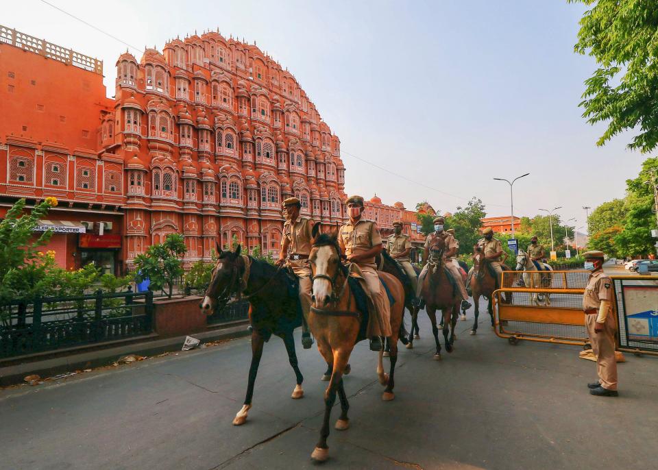 Police personnel mounted on horses conduct a flag march during the lockdown in Jaipur on Sunday, 2 May.