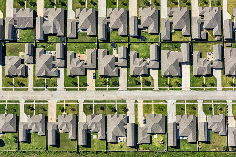 Aerial view of a suburban neighborhood with uniform houses and tidy yards