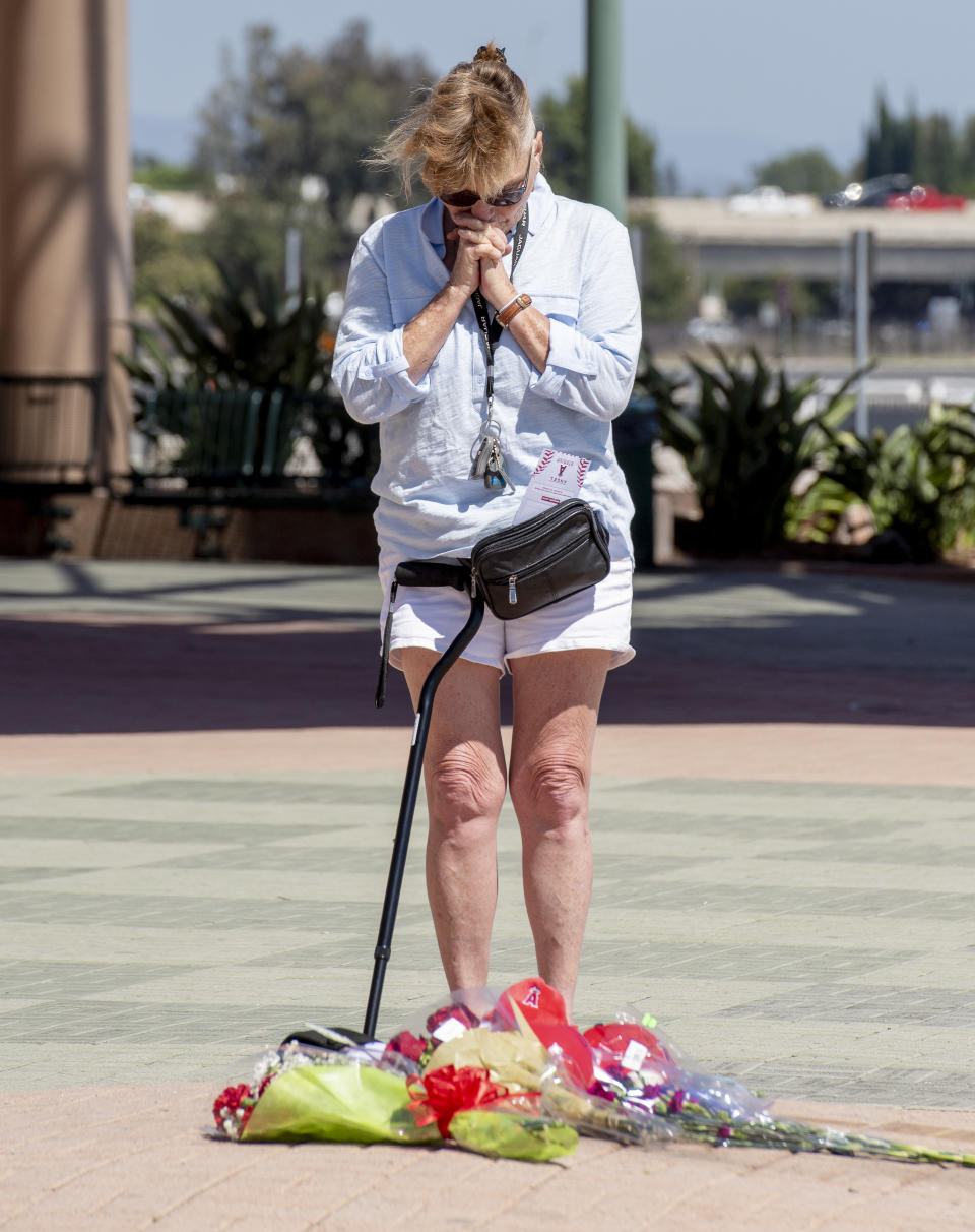 Nancy Dodson of Garden Grove pauses to say a pray at a memorial outside Angel Stadium in Anaheim on Monday, July 1, 2019 in memory of Angel pitcher Tyler Skaggs who died in Texas at the age of 27. Dodson was on the way to Angel Stadium to pick up free tickets when she heard on the news that Tyler had died. (Photo by Leonard Ortiz/MediaNews Group/Orange County Register via Getty Images)