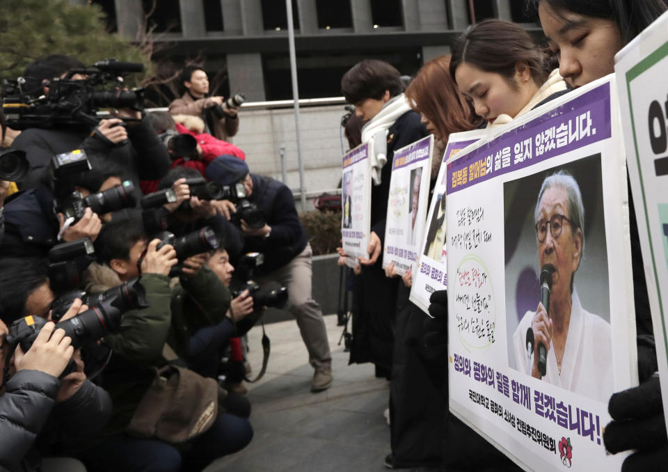 Participants pay a silent tribute as they hold pictures of the deceased Kim Bok-dong, one of the many former South Korean sex slaves who were forced to serve for the Japanese military in World War II, during a weekly rally near the Japanese Embassy in Seoul, South Korea, Wednesday, Jan. 30, 2019. Hundreds of South Koreans are mourning the death of a former sex slave for the Japanese military during World War II by demanding reparations from Tokyo over wartime atrocities. (AP Photo/Lee Jin-man)