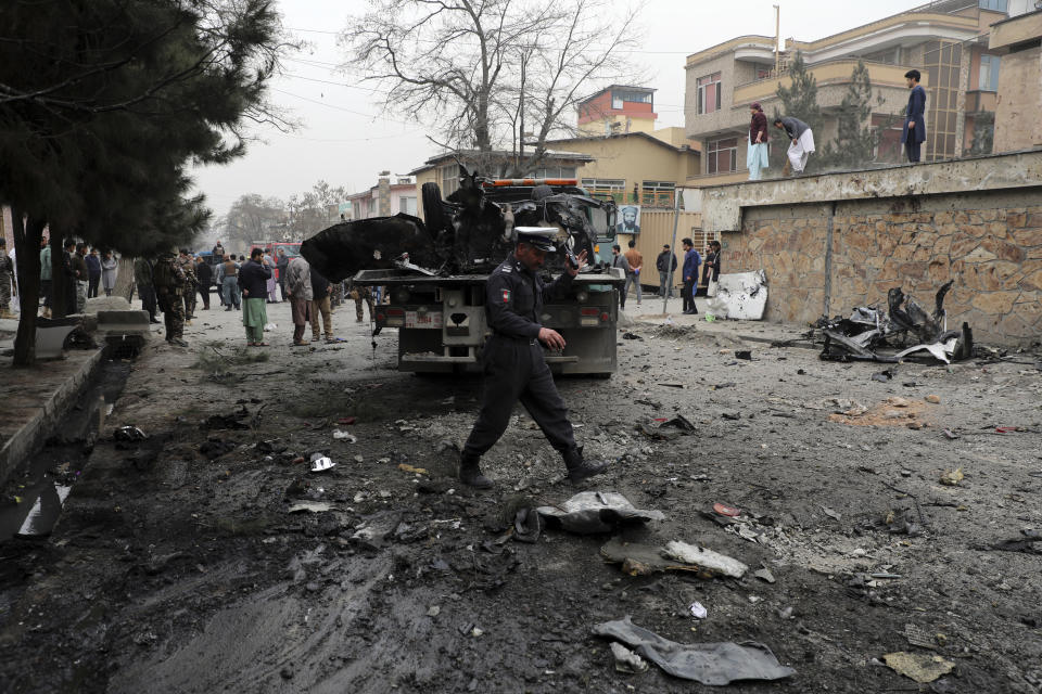 Security personnel inspect the site of a bomb attack in Kabul, Afghanistan, Saturday, Feb. 20, 2021. Three separate explosions in the capital Kabul on Saturday killed and wounded numerous people an Afghan official said. (AP Photo/Rahmat Gul)