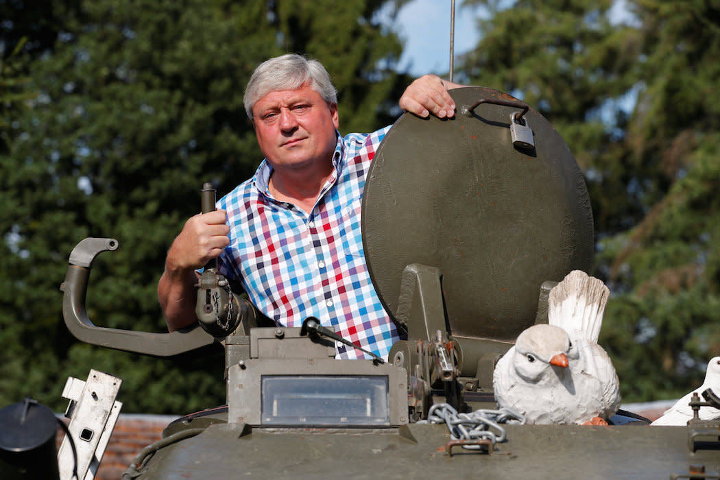 Gary Blackburn looks out of a demilitarised Centurion tank at his “Little Britain” museum in Germany (Picture: Reuters)